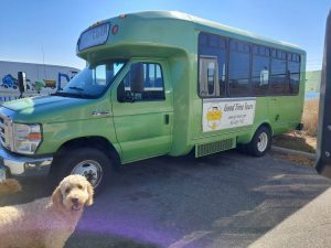 Good Time Tours red rocks party bus with logo on side and dog by bus