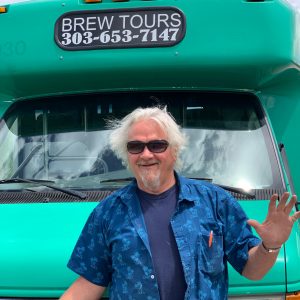 Owner Tom of Good Time Tours in front of denver party bus